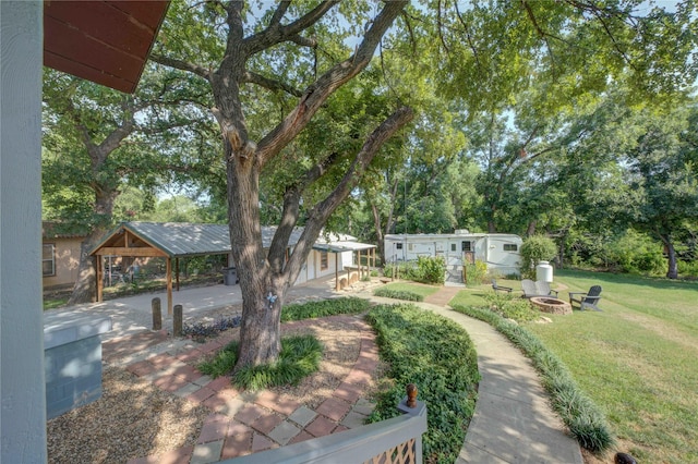 view of yard with a fire pit