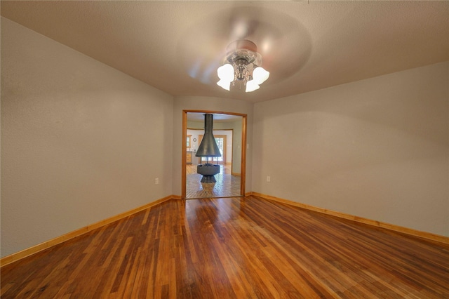 empty room with hardwood / wood-style flooring and ceiling fan