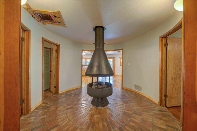 unfurnished dining area featuring a textured ceiling