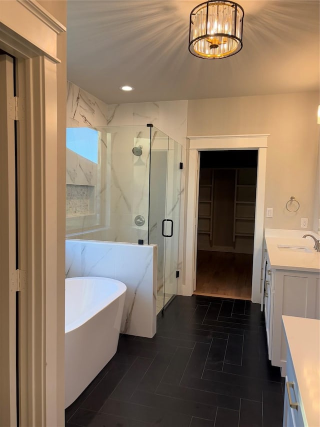 bathroom featuring vanity, tile patterned flooring, a chandelier, and shower with separate bathtub