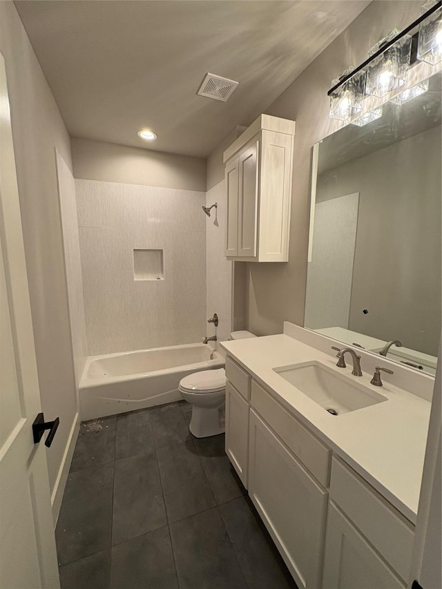 full bathroom with toilet, tile patterned flooring, tiled shower / bath, and vanity