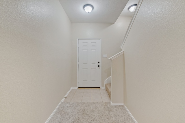 doorway to outside with light carpet