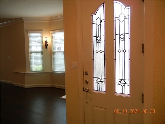 entryway with ornamental molding and hardwood / wood-style flooring