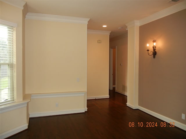 spare room featuring crown molding and dark hardwood / wood-style flooring