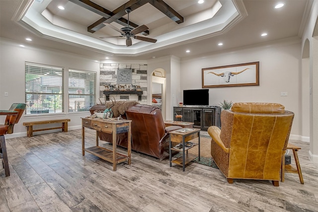 living room featuring a raised ceiling, coffered ceiling, hardwood / wood-style floors, and ceiling fan