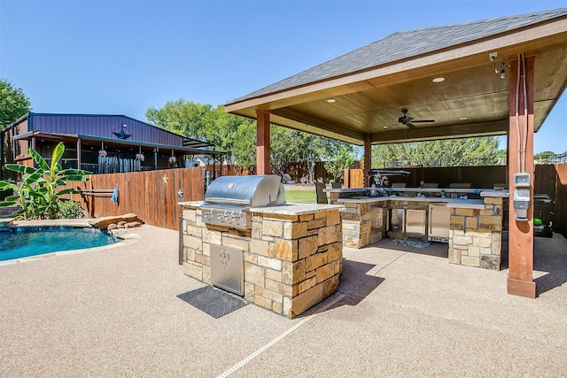 view of patio featuring ceiling fan, area for grilling, a fenced in pool, a gazebo, and exterior kitchen