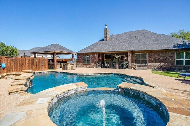 view of pool with a patio, a gazebo, an in ground hot tub, and pool water feature