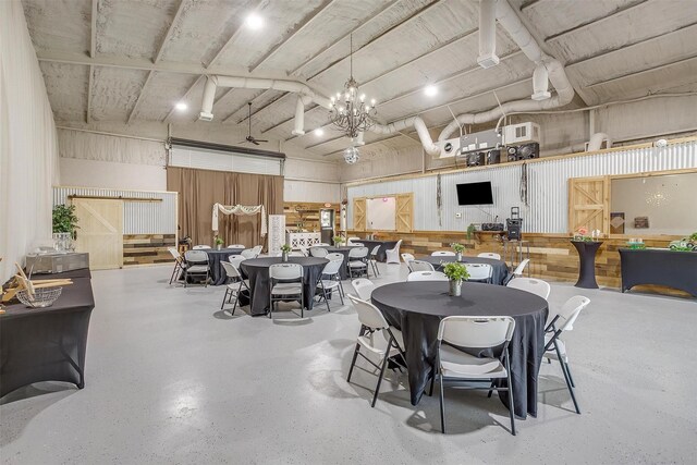 dining area with a high ceiling and a chandelier