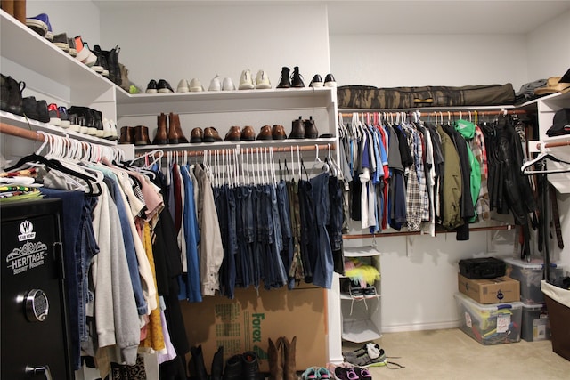 walk in closet with carpet floors