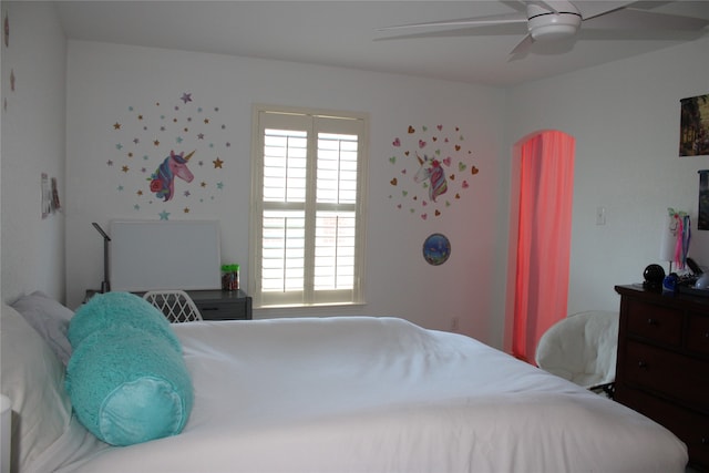 bedroom with ceiling fan and multiple windows