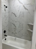 bathroom with tiled shower / bath combo