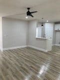 unfurnished living room with ceiling fan and hardwood / wood-style flooring