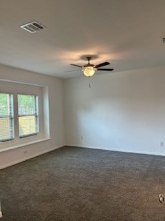 unfurnished room featuring dark carpet and ceiling fan