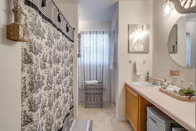 8716 County Road 1224a, Rio Vista, TX 76093 - full bathroom with curtained shower, vanity, and baseboards