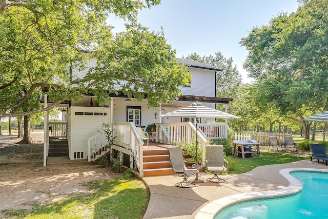 8716 County Road 1224a, Rio Vista, TX 76093 - back of property featuring fence, stairs, a wooden deck, a fenced in pool, and a patio area