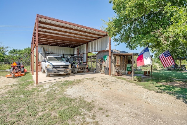 view of vehicle parking featuring a yard and a carport