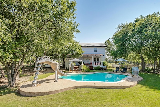 8716 County Road 1224a, Rio Vista, TX 76093 - view of swimming pool with a fenced in pool, a yard, fence, a deck, and a water slide