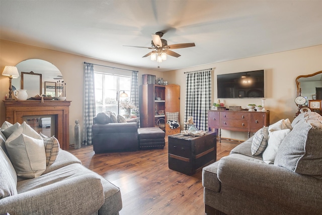 living room featuring dark hardwood / wood-style flooring and ceiling fan