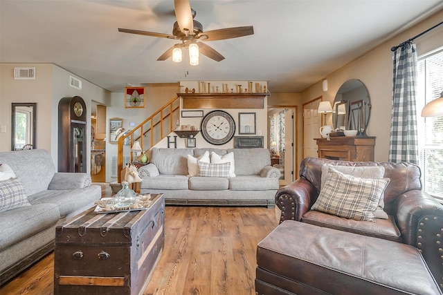8716 County Road 1224a, Rio Vista, TX 76093 - living room featuring stairway, wood finished floors, visible vents, and a ceiling fan