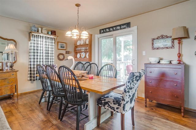 dining area featuring an inviting chandelier and hardwood / wood-style floors