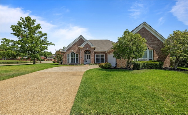 view of front of house with a front yard and a garage