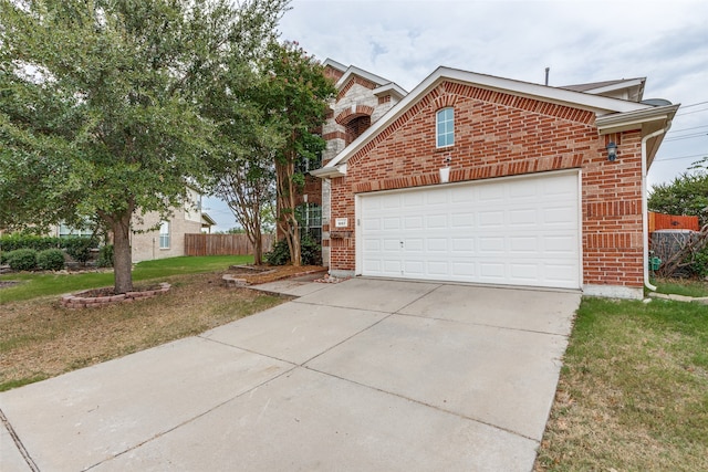 view of front of home featuring a garage and a front lawn