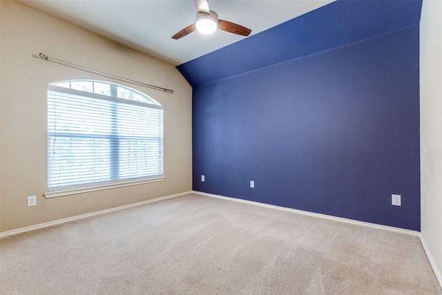 spare room with lofted ceiling, light colored carpet, and ceiling fan