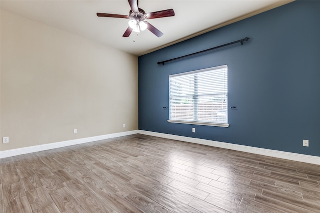 unfurnished room with hardwood / wood-style flooring and ceiling fan