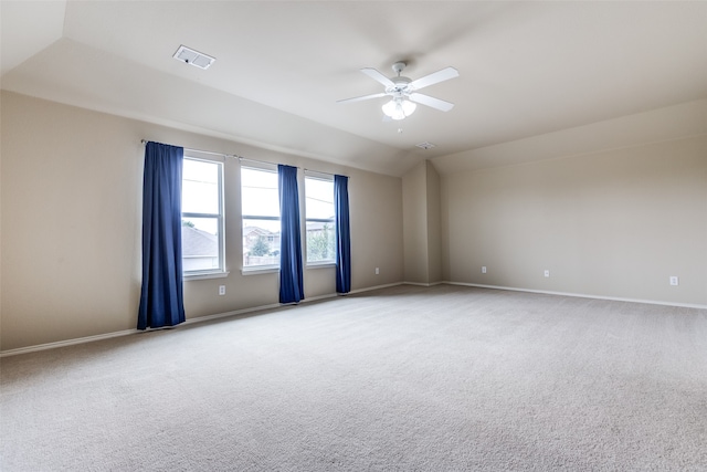 carpeted spare room with vaulted ceiling and ceiling fan