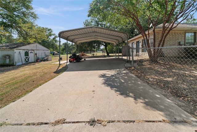 view of vehicle parking with a yard and a carport