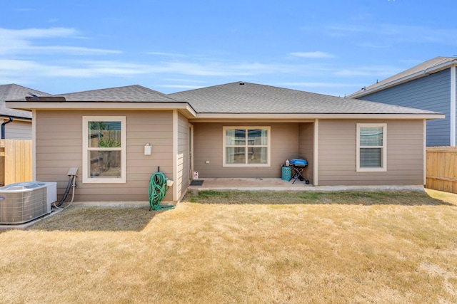 back of property featuring a lawn, a patio, and central AC