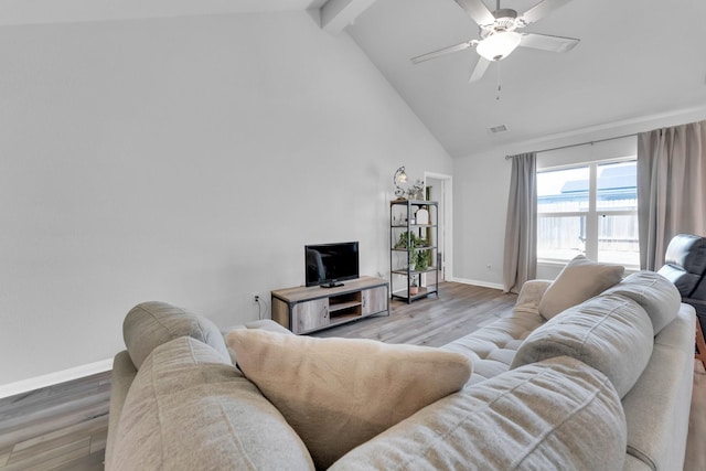 living room with ceiling fan, high vaulted ceiling, light hardwood / wood-style floors, and beam ceiling