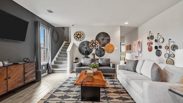 living room featuring a healthy amount of sunlight and light hardwood / wood-style floors