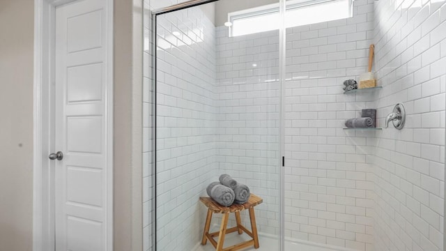 bathroom featuring a shower with door