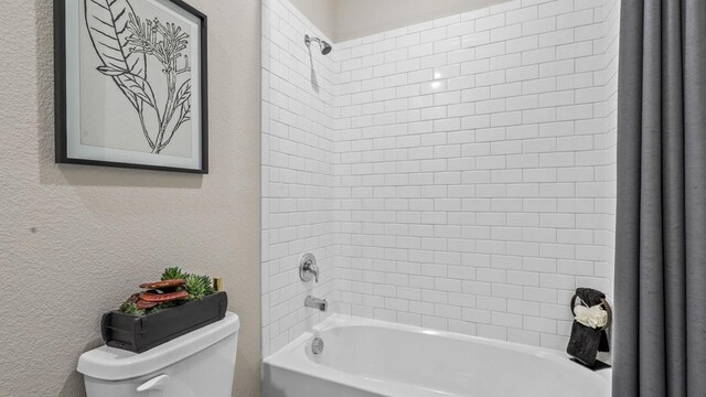 bathroom featuring shower / bath combination with curtain and toilet