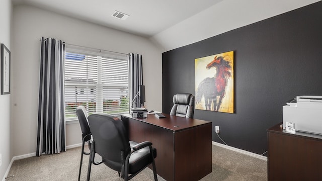 carpeted office space with vaulted ceiling