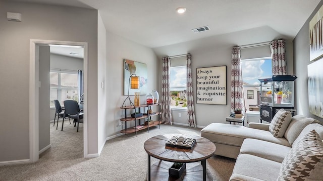 living room featuring carpet floors and a wealth of natural light