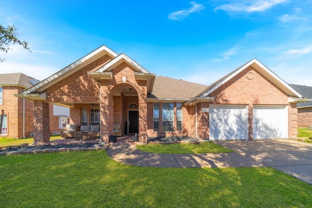 ranch-style house featuring an attached garage, driveway, a front yard, and brick siding