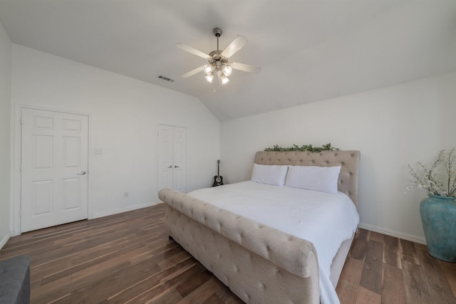 bedroom featuring vaulted ceiling, wood finished floors, visible vents, and baseboards