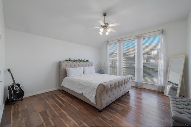 bedroom with lofted ceiling, ceiling fan, wood finished floors, and baseboards