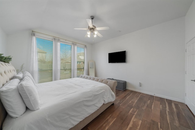 bedroom with dark wood-style floors, ceiling fan, and baseboards