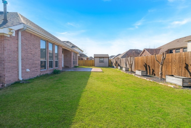 view of yard with an outbuilding, a patio area, a fenced backyard, and a storage shed