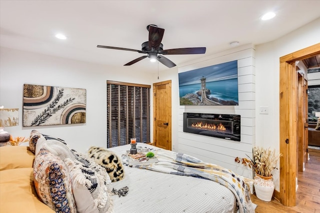 bedroom with hardwood / wood-style flooring and ceiling fan