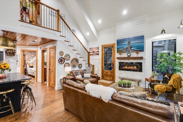 living room with wood-type flooring, wood ceiling, and high vaulted ceiling