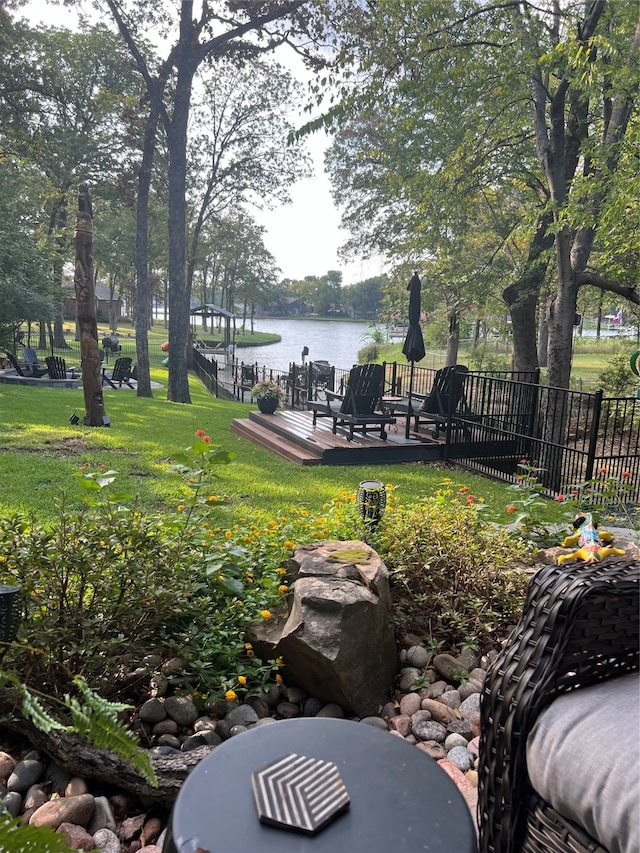 view of yard featuring a deck with water view