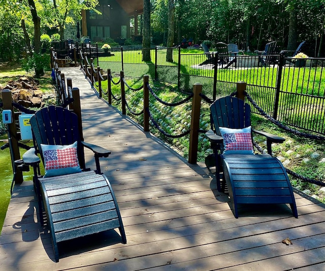 view of home's community featuring a wooden deck and a lawn