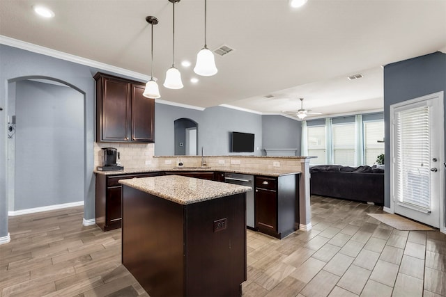 kitchen with tasteful backsplash, stainless steel dishwasher, a center island, kitchen peninsula, and decorative light fixtures