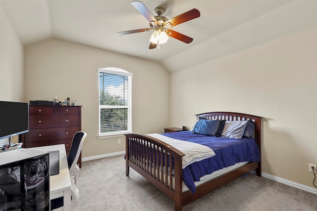 carpeted bedroom with ceiling fan and vaulted ceiling