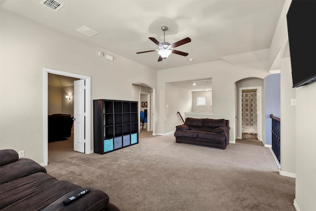 carpeted living room with ceiling fan