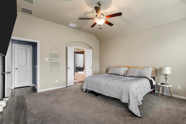 bedroom featuring ensuite bath, lofted ceiling, dark hardwood / wood-style flooring, and ceiling fan